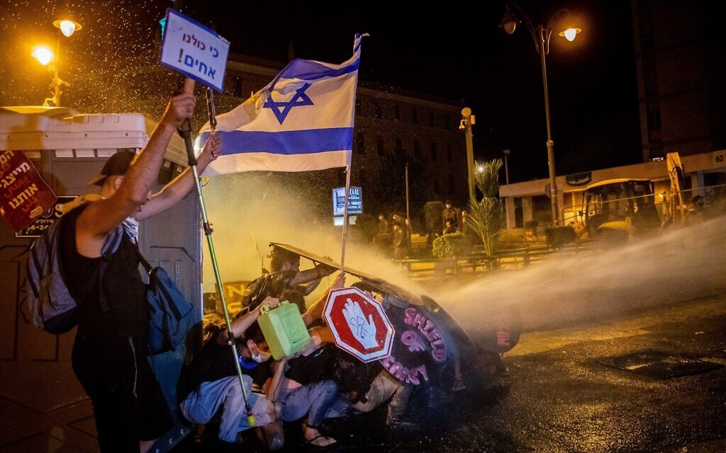 Israeli Police use a water cannon to disperse demonstrators during a protest against Israeli prime minister Benjamin Netanyahu outside the prime minister's residence in Jerusalem on July 26, 2020. Photo by: JINIPIX