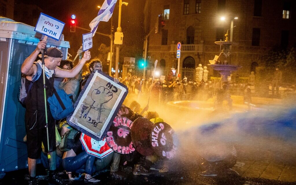 Israeli Police use a water cannon to disperse demonstrators during a protest against Israeli prime minister Benjamin Netanyahu outside the prime minister's residence in Jerusalem on July 26, 2020. Photo by: JINIPIX