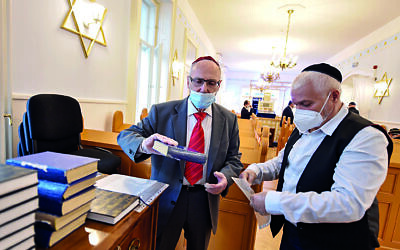 The new normal: gloves and masks are temporary but Covid will also bring lasting changes. This synagogue is in Hungary