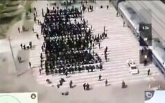 Screenshot from Twitter of alleged Uyghur prisoners, blindfolded and cuffed being loaded on to trains. (Via Jewish News)