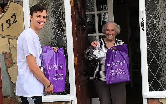 Volunteer Jamie Shone delivers a goody bag to 90 year-old Jewish Care resident Anita Frankle