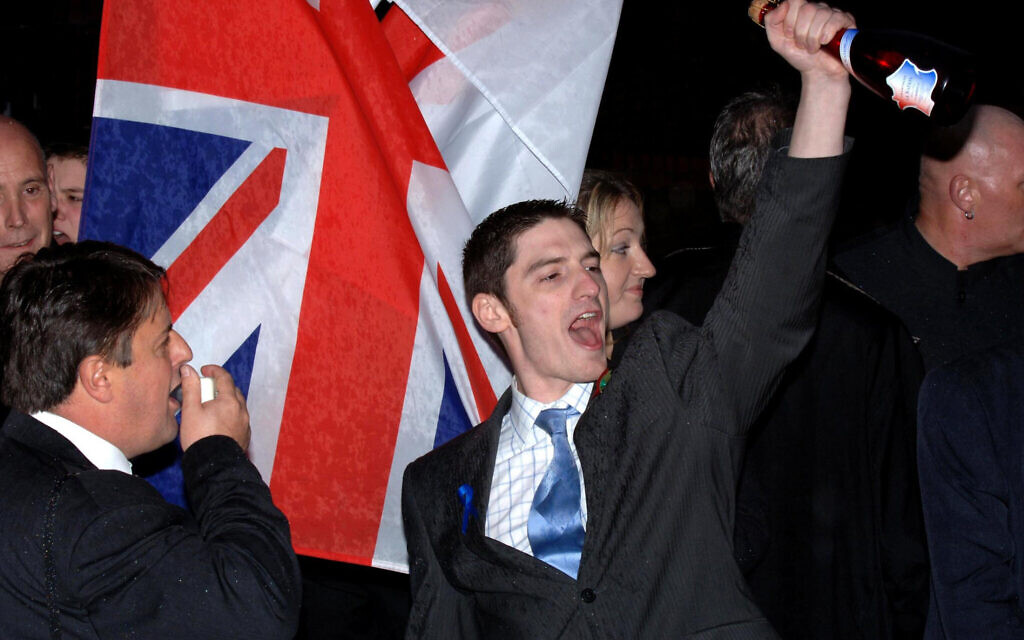 BNP's former Leader Nick Griffin (left) and Mark Collett, open champagne as they were cleared of race hate charges at Leeds Crown Court.