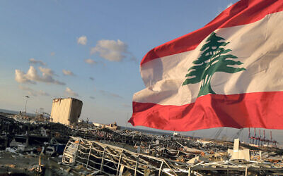 A Lebanese flag flies near the site where a massive explosion blasted the port of Beirut  Photo: Marwan Naamani/dpa