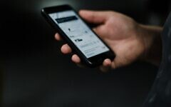 Stock image of a person holding a phone (Credit: Priscilla Du Preez on Unsplash)