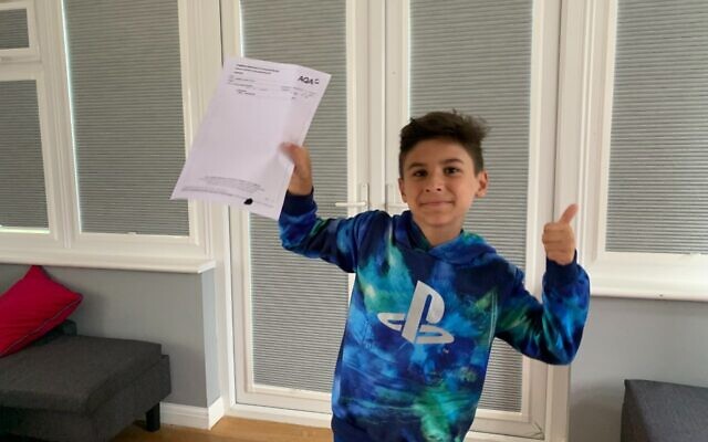 Rafi pictured with his GCSE result (Credit: Family handout)