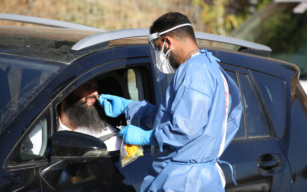 Israeli medical personnel take samples at a drive through COVID-19 testing facility in the northern city of Tzfat, on September, 29 2020. Israel has registered more than 234,060 coronavirus cases with 1,516 deaths, out of a population of nine million. Photo by: David Cohen-JINIPIX