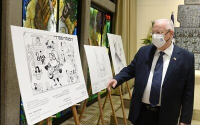 President Rivlin inspects cartoons at the exhibit