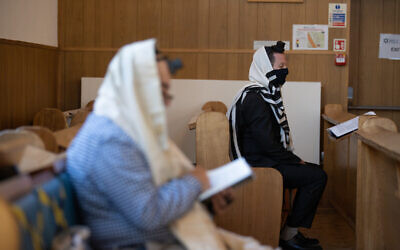 Mill Hill United synagogue's Rabbi Yitzchak Schochet (right) praying under Covid restrictions (Marc Morris)