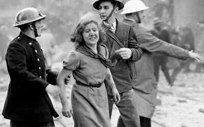 A young woman still smiling after being rescued from a London building just wrecked by a bomb dropped by a daylight German Luftwaffe raid.