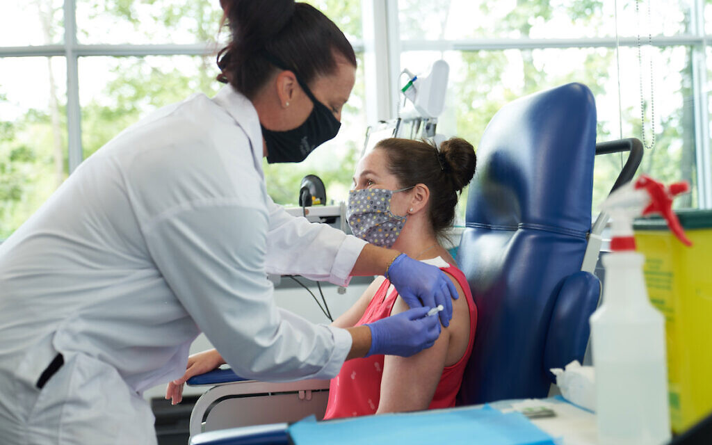 A volunteer participates in a clinical trial for its COVID-19 vaccine candidate (Photo: PA/Business Wire)