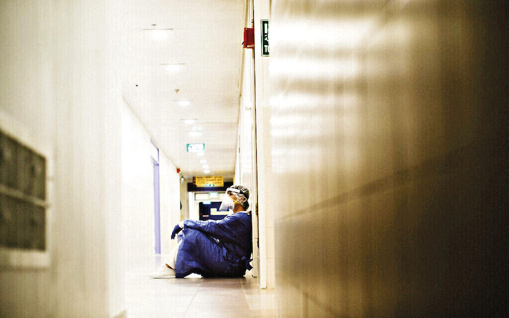 An exhausted staff member at Haifa’s Bnai Zion Medical Center