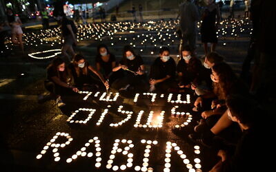 Israelis light candles, as part of a display of 25,000 memory candles in honor of the 25th Memorial Day for the assassination of late Prime Minister Yitzhak Rabin, at Rabin Square in Tel Aviv on October 29, 2020. Photo by Tomer Neuberg/Flash90