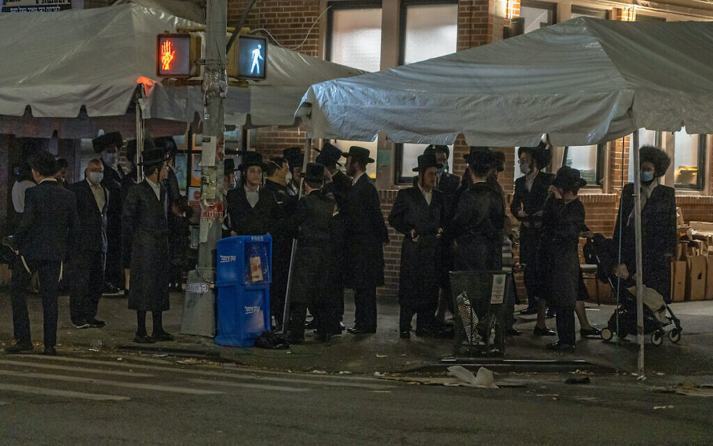 Orthodox Jewish men gather on the Jewish holiday of Simchat Torah at the Borough Park neighborhood of Brooklyn.
 (Photo by Ron Adar / SOPA Images/Sipa USA)