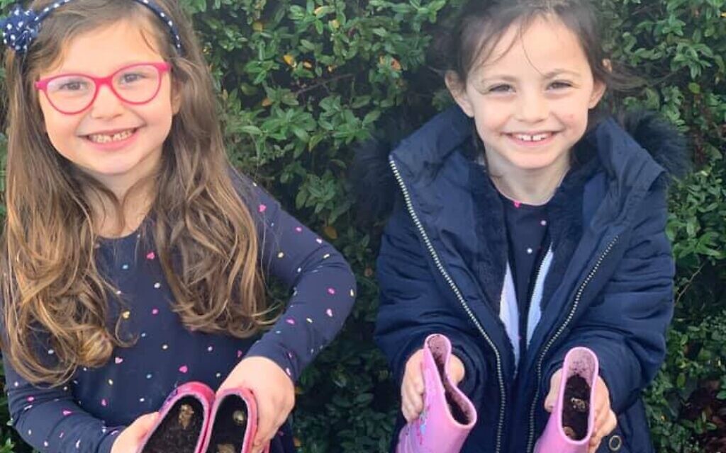 Younger members of Stanmore, Liora and Aviva Turgel planting bulbs in their wellies