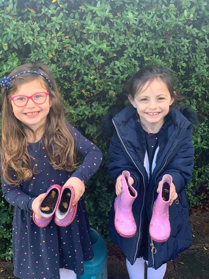 Younger members of Stanmore, Liora and Aviva Turgel planting bulbs in their wellies