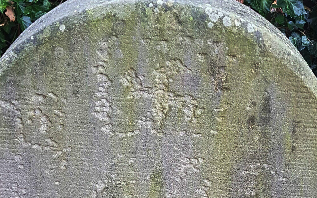 A swastika carved into a headstone at the Jewish cemetery of Haren, Germany in November 2020. (Courtesy of the Jewish Community of Haren/Eli Nahum/Monitoring Antisemitism Worldwide)