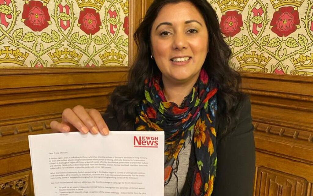 Nus Ghani holding the Uyghur petition