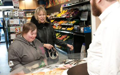 Debbie who is supported by Kisharon, shopping. The picture was taken pre-coronavirus pandemic.