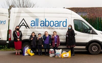 Youngsters (pictured with headteacher Rita Alak-Levi and deputy headteacher Lisa Wolf) at Hertsmere Jewish Primary School enjoy their doughnuts, which were sponsored by All Aboard as a thank you for a huge collection drive. Credit: Claire Jonas Photography