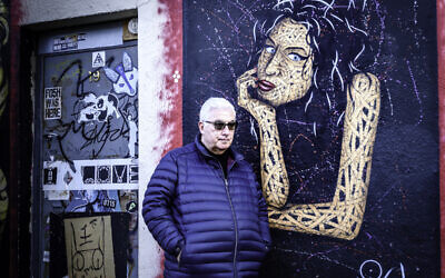 Mitch Winehouse next to a mural of Amy