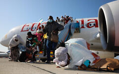 Ethiopian olim exiting the plane after touching down at Ben Gurion Airport, 2020 (Credit: Olivier Fitoussi, courtesy of The Jewish Agency for Israel)