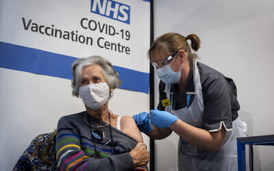 Dr Doreen Brown, 85, receives the first of two Pfizer/BioNTech Covid-19 vaccine jabs, at Guy's Hospital in London, on the first day of the largest immunisation programme in the UK's history. Care home workers, NHS staff and people aged 80 and over began receiving the jab this morning.