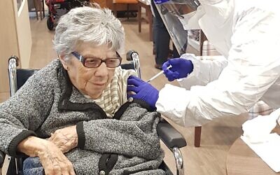 Marion Phillips, 95, receives her vaccination at Jewish Care's Anita-Dorfman house