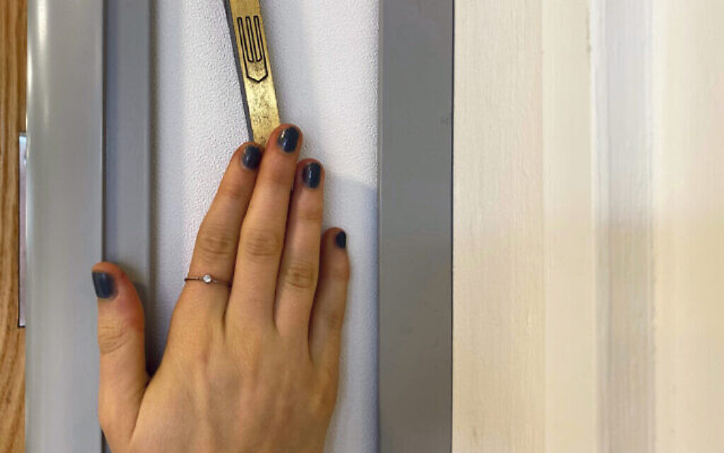 Hand on a Mezuzah