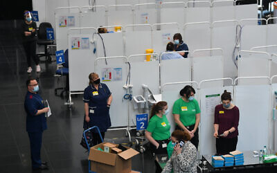 Members of staff prepare to administer injections of a Covid-19 vaccine at the NHS vaccine centre that has been set up at the Millennium Point centre in Birmingham.