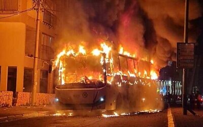 A bus set alight by a mob in the city of Bnei Brak, January 24, 2021. (Israel Police via Times of Israel)