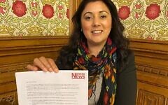 Nus Ghani holding the Uyghur petition signed by 150 Parliamentarians