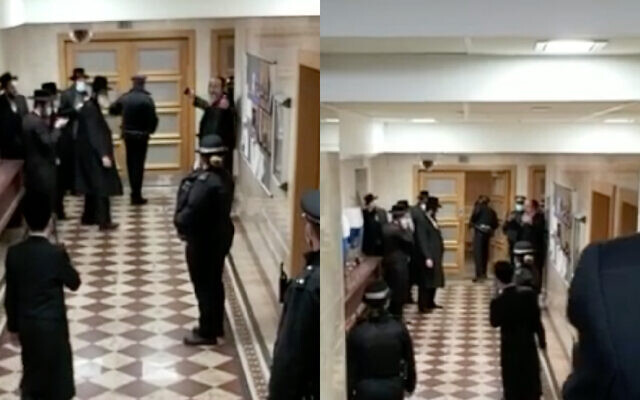 Screenshot from Jewish News' video last week, in which police were filmed intervening at a Charedi wedding. Rabbi Yossi Teitelbaum is believed to be pictured top right with his hands outstretched.