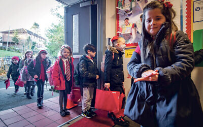 Pupils arrive at primary school.