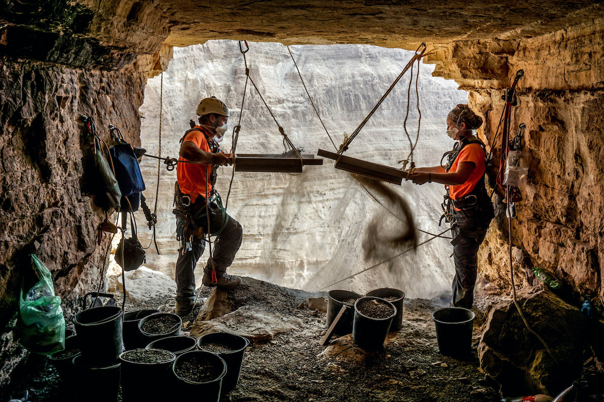 Archeologists Hagay Hamer and Oriah Amichai sifting finds at the Horro Cave. Credit: Eitan Klein Israel Antiquities Authority