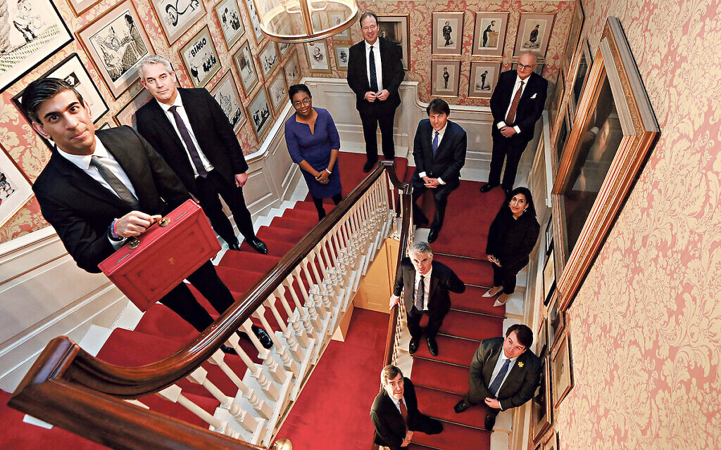 Chancellor of the Exchequer Rishi Sunak holds the budget box as he poses with Chief Secretary to the Treasury Steve Barclay, Exchequer Secretary to the Treasury Kemi Badenoch, Financial Secretary to the Treasury Jesse Norman, Economic Secretary to the Treasury John Glen, Minister of State for Efficiency Theodore Agnew, PPS to Treasury Claire Coutinho, PPS to Chancellor James Cartledge, PPS to Chief Secretary Craig Williams and Government Whip and Lord Commissioner of HM Treasury David Rutley inside 11 Downing Street, London, before heading to the House of Commons to deliver his Budget. Picture date: Wednesday March 3, 2021.