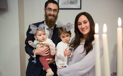 Chabad-Lubavitch Rabbi Avi Feldman, left, Mushky Feldman, right, and their two daughters, Chana and Batsheva, celebrate Hanukkah in Reykjavik, Iceland, Dec. 17, 2017. 
 
Credit: Chabad.org