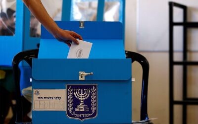 2F3JHDR An Israeli soldier casts his early vote in the March 23 general election, amid the coronavirus disease (COVID-19) crisis, at a mobile polling station at a military base, near Kibbutz Regavim, Israel March 17, 2021. REUTERS/Corinna Kern