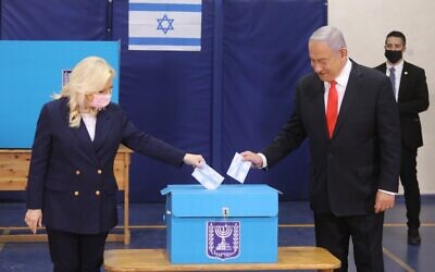 Israeli Prime Minister Benjamin Netanyahu casts his vote during the Israeli parliamentary elections in Jerusalem on March 23, 2021. (Marc Israel Sellem/JINI/Handout via Xinhua)