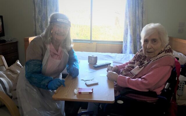 Ethel Fedor, 105, plays cards with her daughter Ros during a designated visit