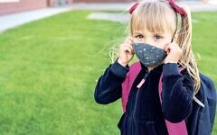 A schoolgirl with a mask (Image:Getty) A schoolgirl with a mask (Image:Getty)