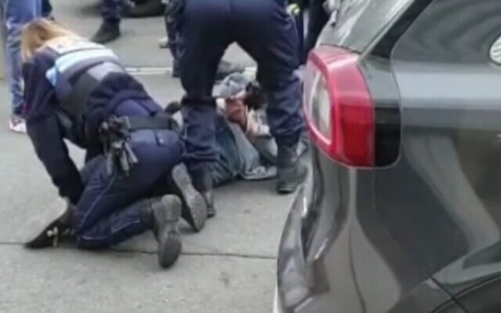 Police arrest a man armed with a knife outside a Jewish school and kosher market in Marseille, France, March 5, 2021 (video screenshot via Times of Israel)