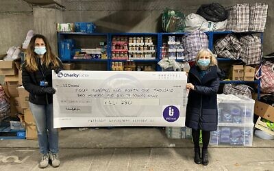 US Chesed’s Michelle Minsky (r) and Yael Peleg (l) holding the appeal cheque standing in front of the US food bank which supports 120 families every week