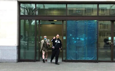 Screen grab of Ben Raymond (right), 31, leaving Wesminster Magistrates' Court, London where he faced four charges, including membership of a proscribed organisation contrary to Section 11 of the Terrorism Act between December 17 2016 and September 27 2017, and three counts of possessing material likely to be useful for terrorism under Section 58 of the act. Raymond did not indicate pleas to any of the charges.