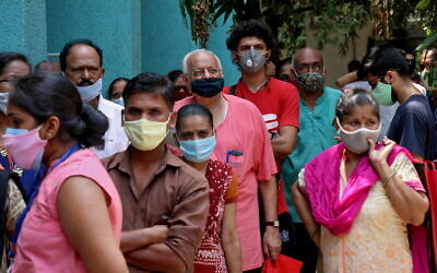 People wearing protective face masks wait to receive a vaccine at a centre in Mumbai (Photo: REUTERS/Niharika Kulkarni)