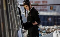A strictly-Orthodox youth inspects leftover personal items at Mount Meron after the stampede (Photo:Ilia Yefimovich/dpa/Alamy Live News) A strictly-Orthodox youth inspects leftover personal items at Mount Meron after the stampede (Photo:Ilia Yefimovich/dpa/Alamy Live News)