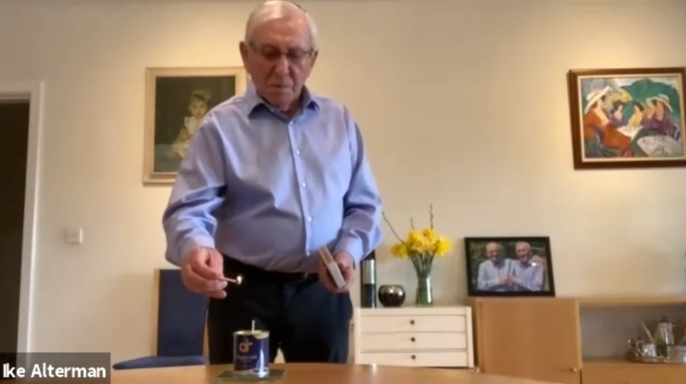 Ike Alterman lighting a candle for Yom HaShoah