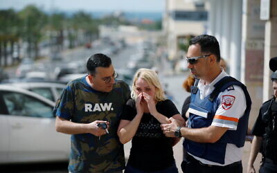 A woman at the scene where a rocket launched from the Gaza Strip hit Ashkelon on Tuesday (Photo: Reuters/Amir Cohen)