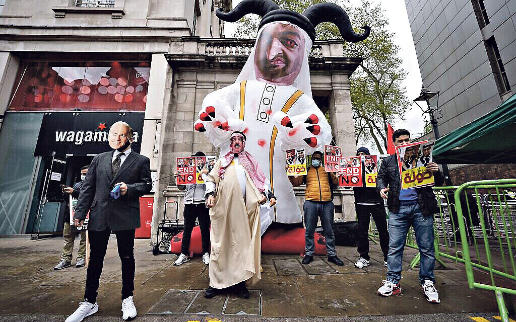 Pro-Palestinian demonstrators march through central London holding signs and flags to mark Nakba Day.