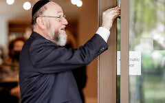 Chief Rabbi Mirvis affixing the Mezuza at the new home