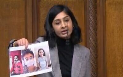 Zarah Sultana holding up pictures of three children killed in Gaza
